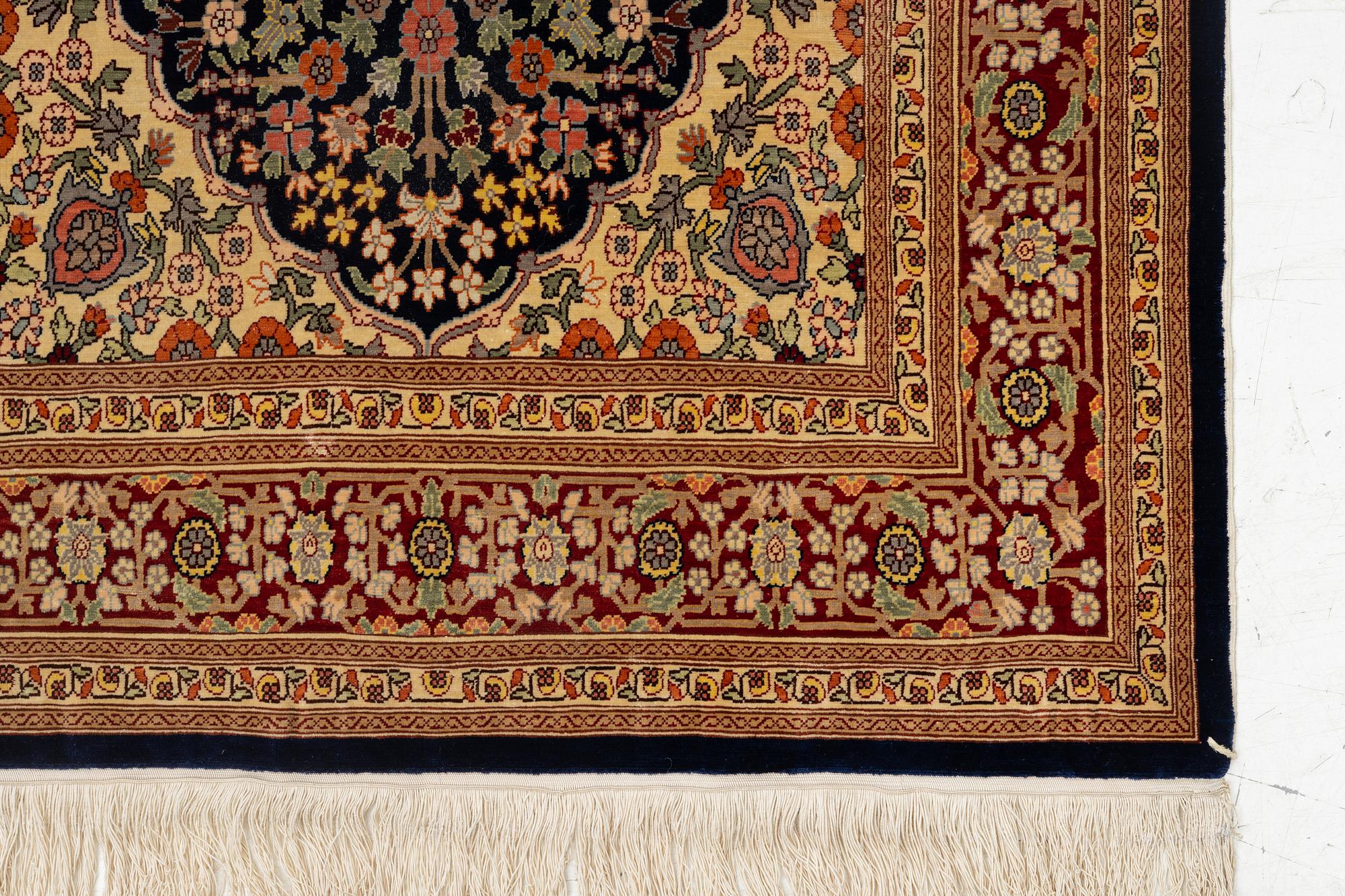 A Hereke silk rug, c. 130 x 71 cm.