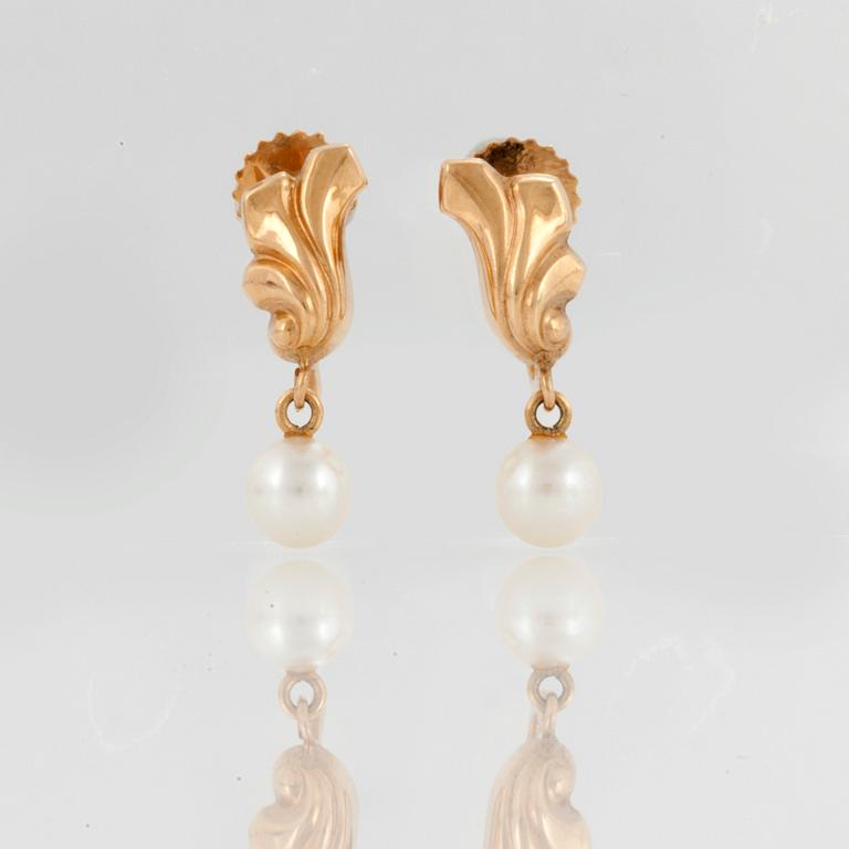 A pair of earrings set with cultured pearls.