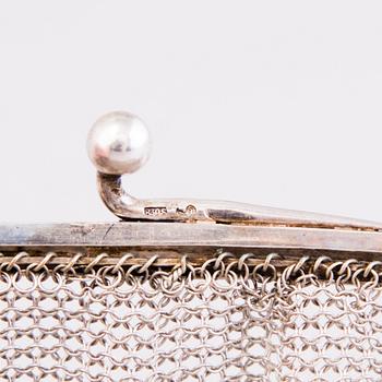 Two silver evening bags and a silver mirror, 1920s-1940s.