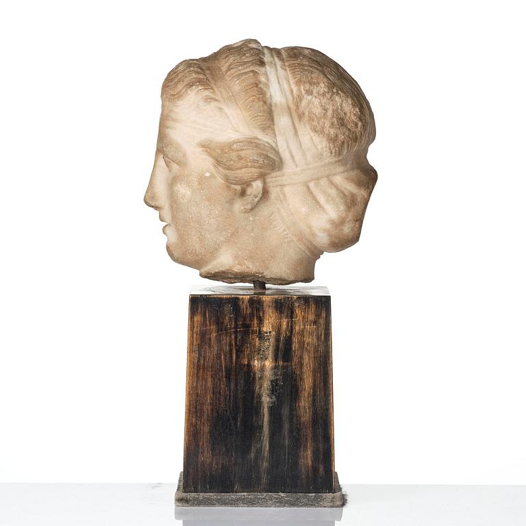 A Greek marble head of a deity wearing a Dionysiac fillet, Hellenistic style presumably 16th century.