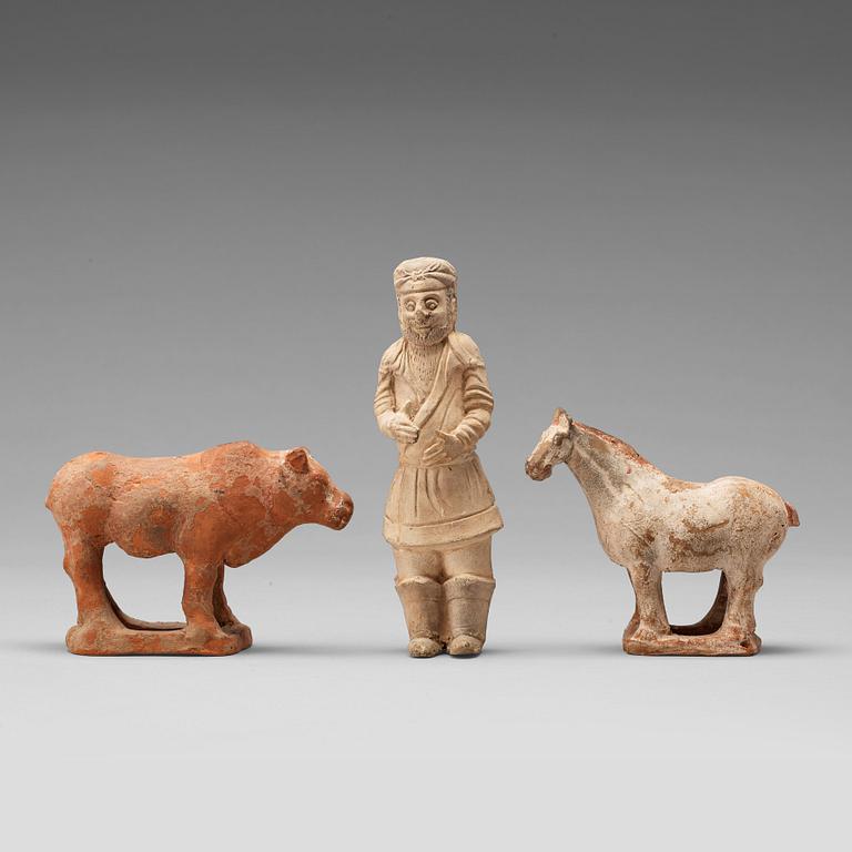 Three pottery scultpures of animals and a herdsman, Tang dynasty (618-906).