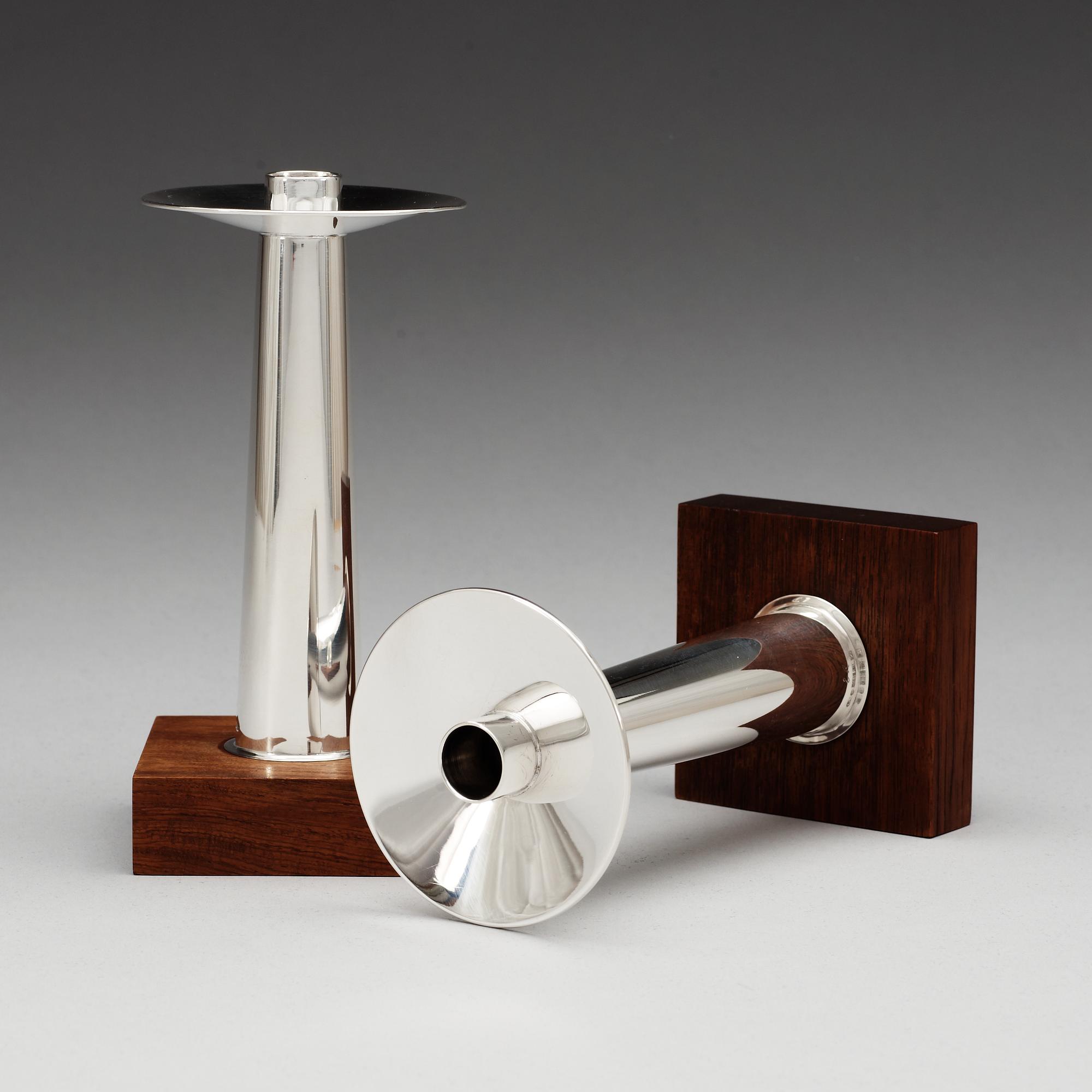 A pair of Finnish silver candlesticks on a teak base, Kultakeskus OY, Tavastehus, Finland 1963.