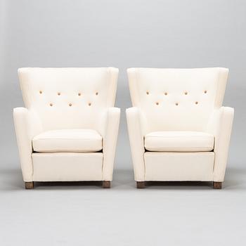 A pair of mid-20th-century armchairs.