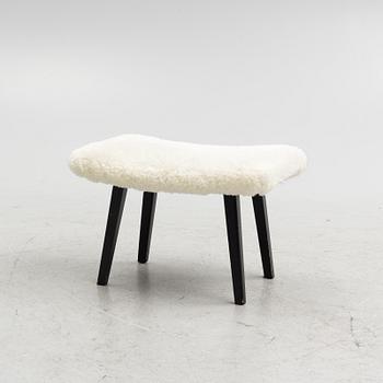 A mid 20th Century stool with sheepskin upholstery.