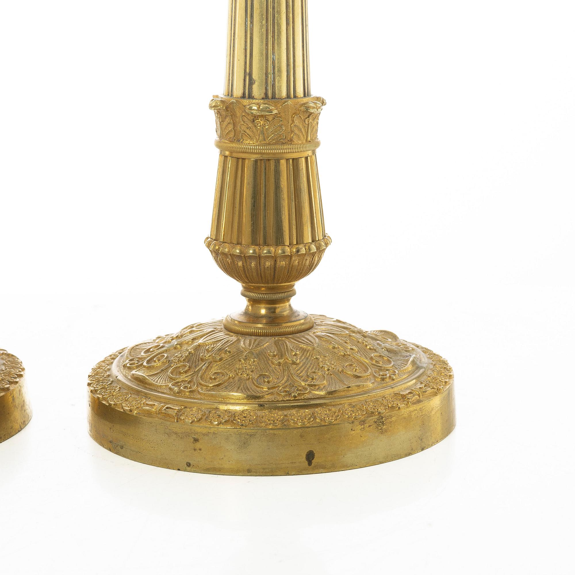 A pair of French Empire candlesticks, early 19th century.