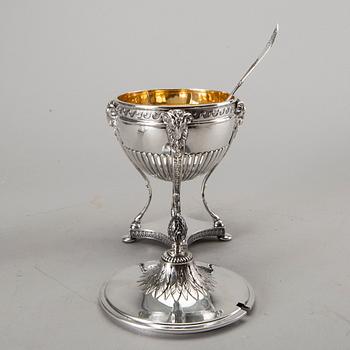 A silver bowl on foot, a pair of candlesticks and a spoon. early 20th century. Total weight app. 800 gram.