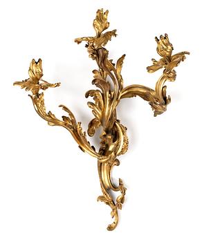 A pair of Louis XV-style 19th century three-light wall-lights.