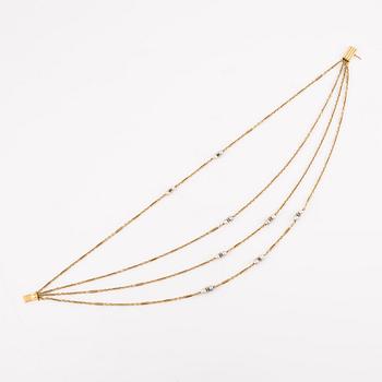 A W.A. Bolin necklace in 18K gold with pearls and white discs.