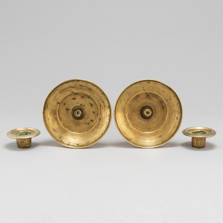 A mid 19th Century pair of brass candle sticks.