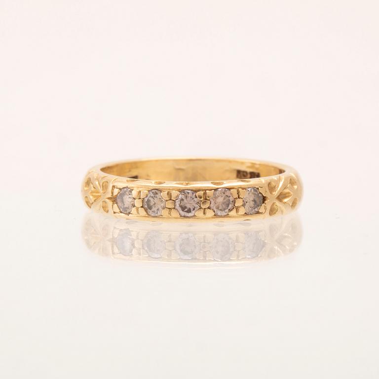 An 18K gold half-eternity ring set with round brilliant-cut diamonds.