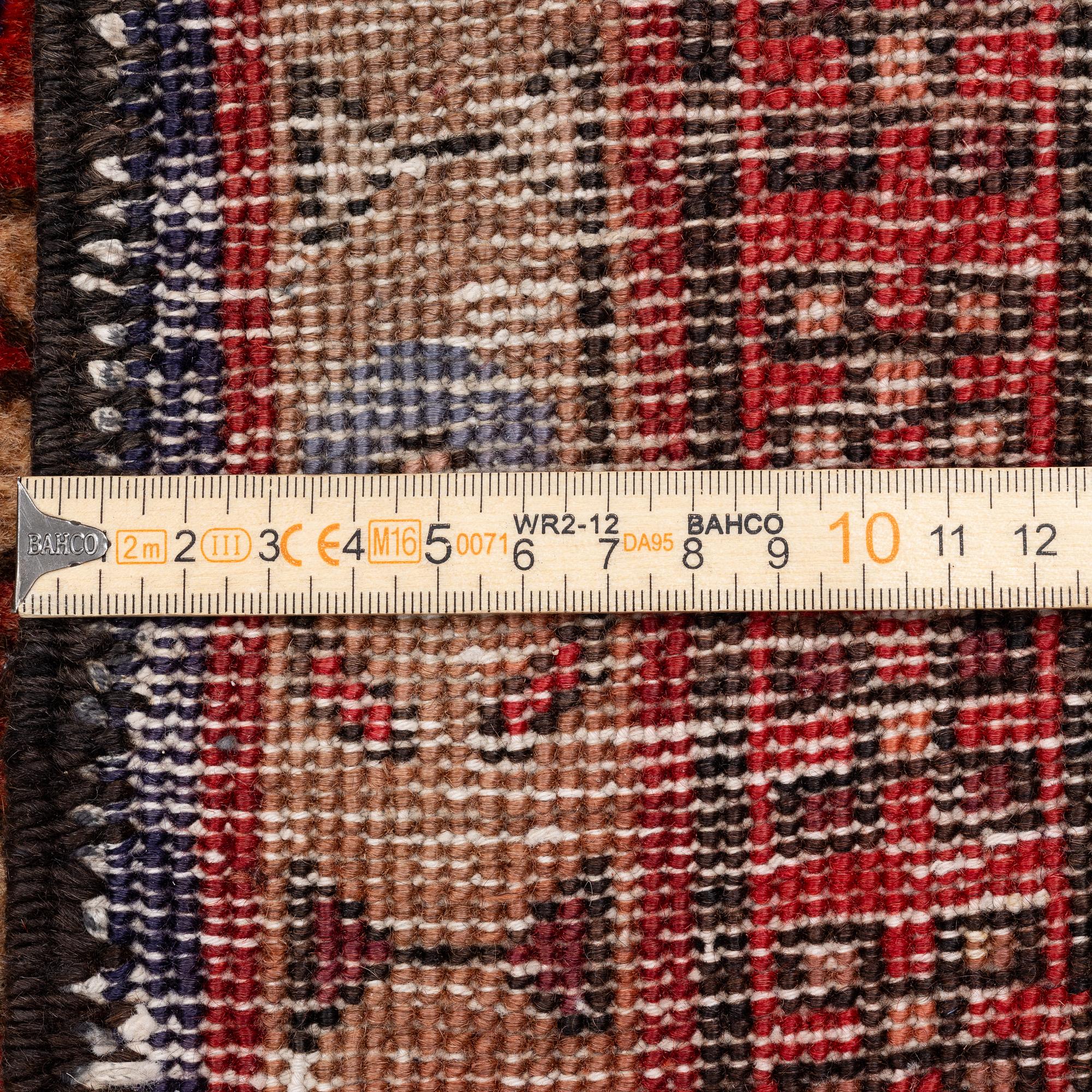 A Sarab carpet, c. 305 x 137 cm.