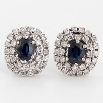 Oval faceted sapphire and eight-cut diamond cluster earrings.