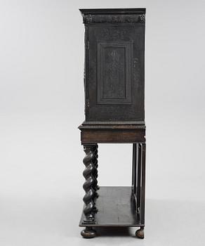 A Louis XIV and Louis XIV-style carved ebony, ivory and tortoiseshell-inlaid cabinet on stand, 17th and 19th century.