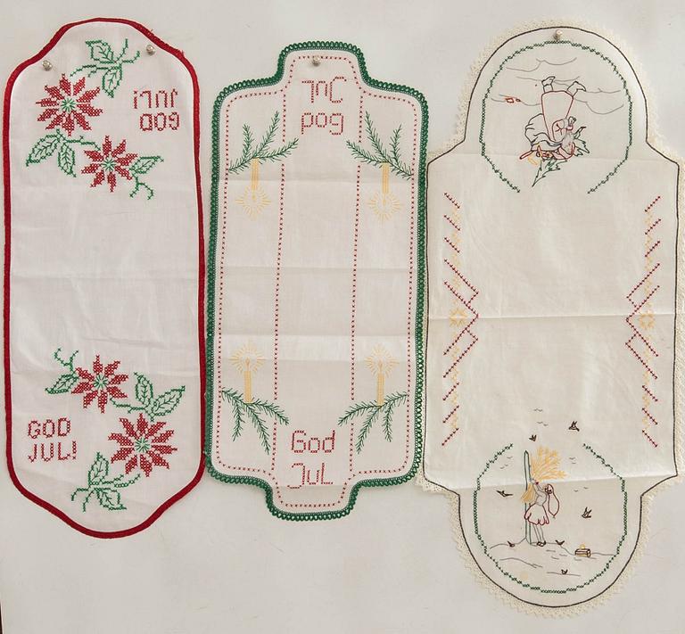 A collection of smaller Christmas tablecloths, runners, and wall hangings, approximately 34 pieces, mid/second half of the 20th century.