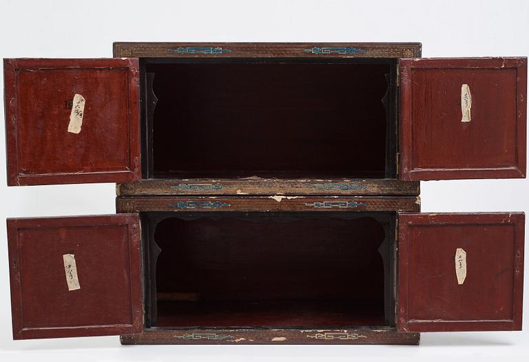 A lacquered cabinet, in two sections, Qing dynasty, 19th Century.