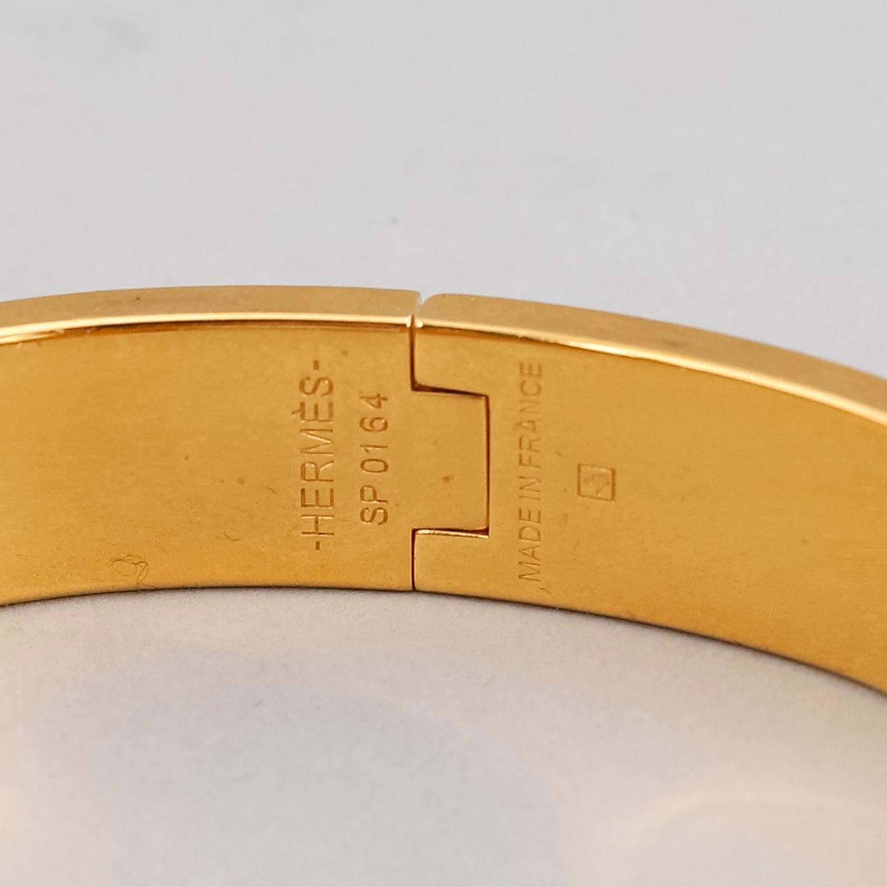 HERMÈS, a 'Clic H' bangle.