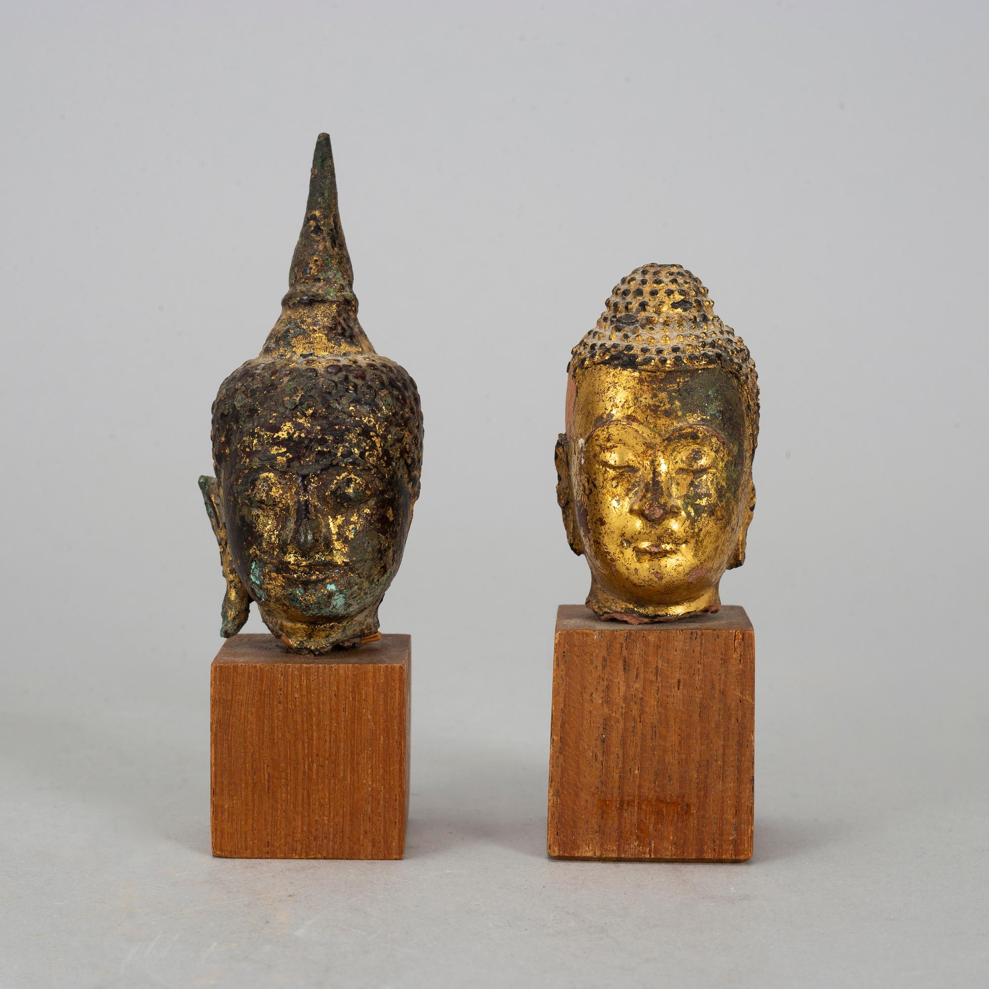 A group of two heads in wood and bronze, Thailand, Bangkok, circa 1900.