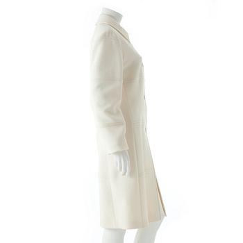 CARACTÈRE, a white wool coat.