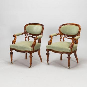 A pair of Russian armchairs and a table, late 19th century.