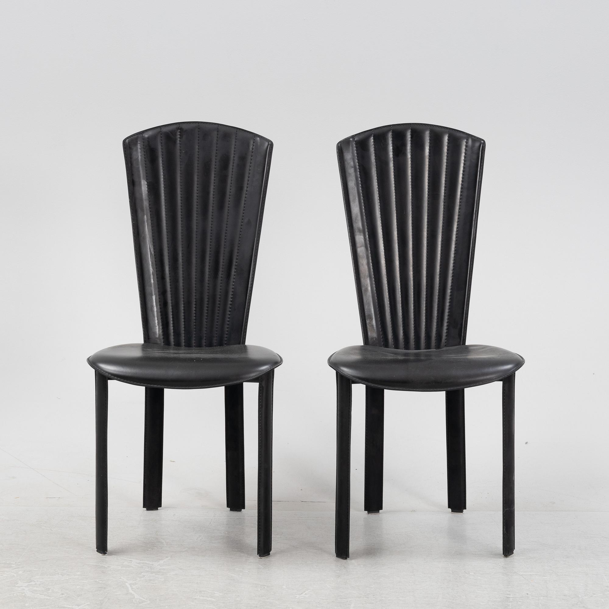 Twelve black leather 'Sossano' chairs, Quia, Italy.