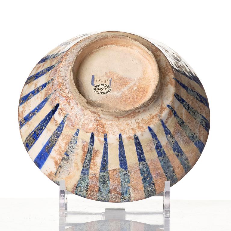A cobalt glazed radila design pottery bowl, Persia (Iran), 12th/13th century.