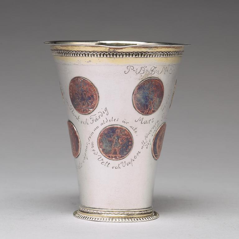 A Swedish 18th century parcel-gilt silver beaker with copper coins, mark of CM Ekman, Eksjö (1729-1738).