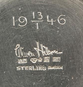 A Swedish 20th century sterling set of three sandwich spoons ad a beaker mark of W Nilsson Lund 1965, 1967 and 1946,