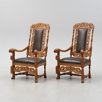 A pair of carved oak Baroque style armchairs, circa 1900.