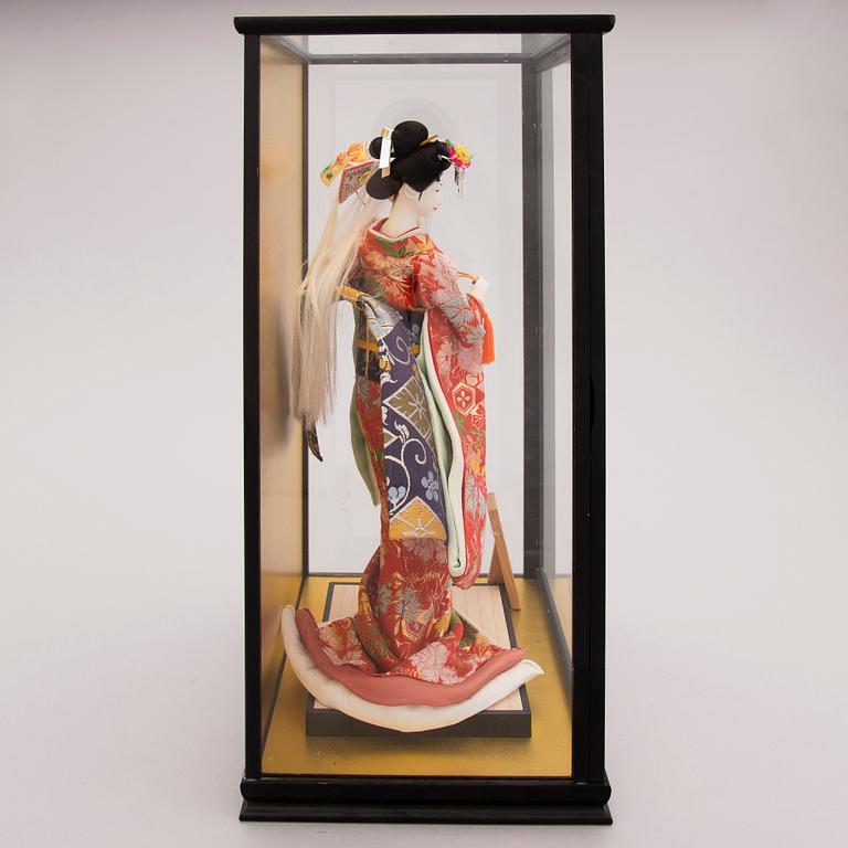 A latter half of the 20th century Japanese doll in showcase.