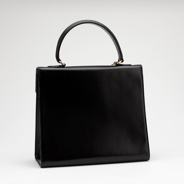 CÉLINE, a black leather top handle purse.