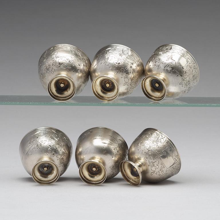 A set of six Ottoman parcel-gilt silver Xarfs with Russian Kuznetzov porcelain cups, c. 1910.