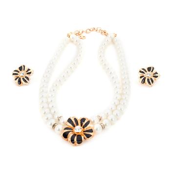 CHRISTIAN DIOR, a necklace with white decorativ perals and flowershaped clip earings in gold colored metal.