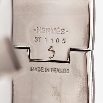 Hermès, A "Click H" bracelet made of metal and yellow enamel. Marked Hermès, ST1105, S, Made in France.