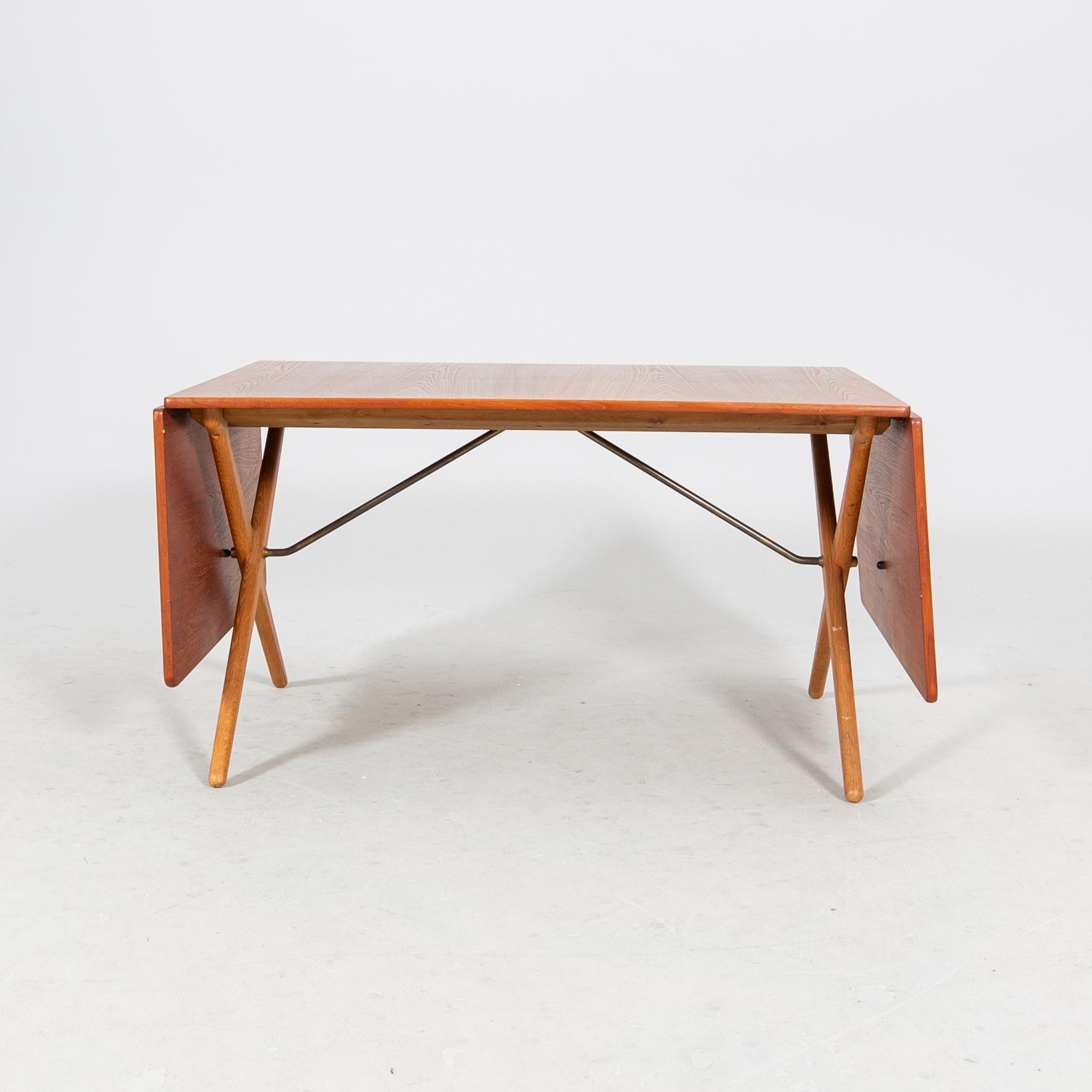 A Hans J Wegner "Savbukkebordet AT-303", teak and oak drop-leaf dining table, Andreas Tuck, Denmark 1950s-1960s.