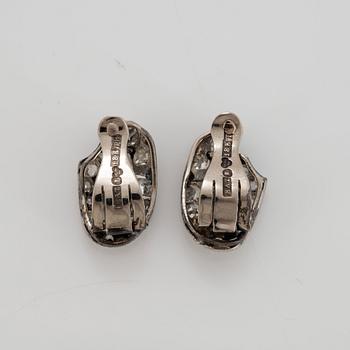 A pair of 18K white gold earrings set with faceted emeralds and old- and eight-cut diamonds.