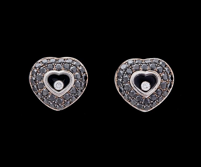 A pair of black and white Chopard 'happy diamond' heart earrings.