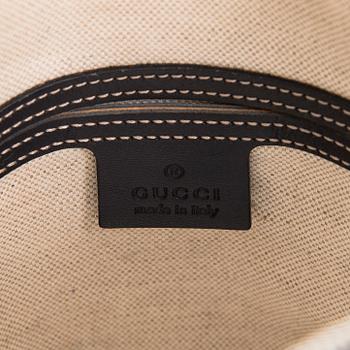Gucci, A "GG Supreme messenger" bag.