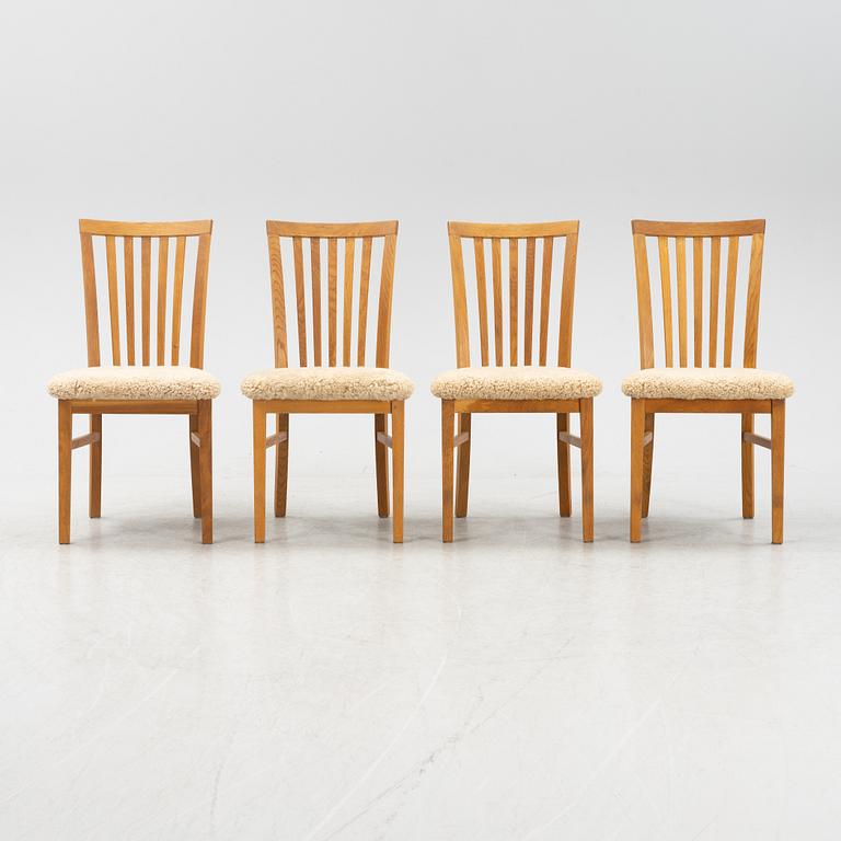 A set of four oak chairs with new  sheepskin upholstery.
