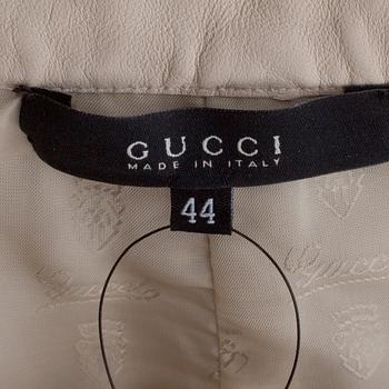 GUCCI, a white leather skirt.