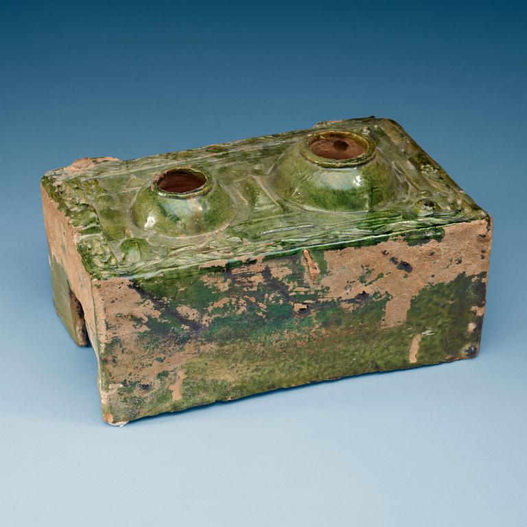 A green glazed pottery model of a stove, Han dynasty  (206 BC– AD 220).