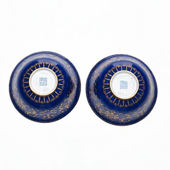 A pair of gilt decorated blue ground painted enamel bowls, Qianlong four character seal mark and period (1736-95).