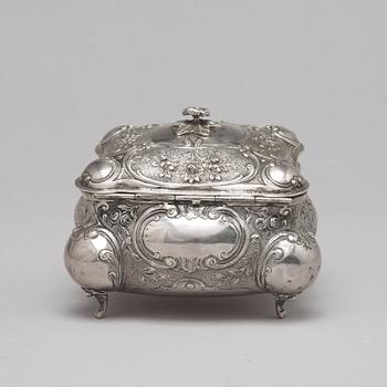 A silver sugar box.