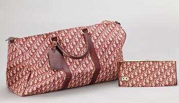 A red monogram canvas weekendbag and clutch by Christian Dior.