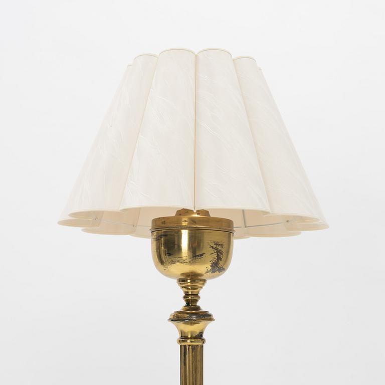 A brass floor lamp.