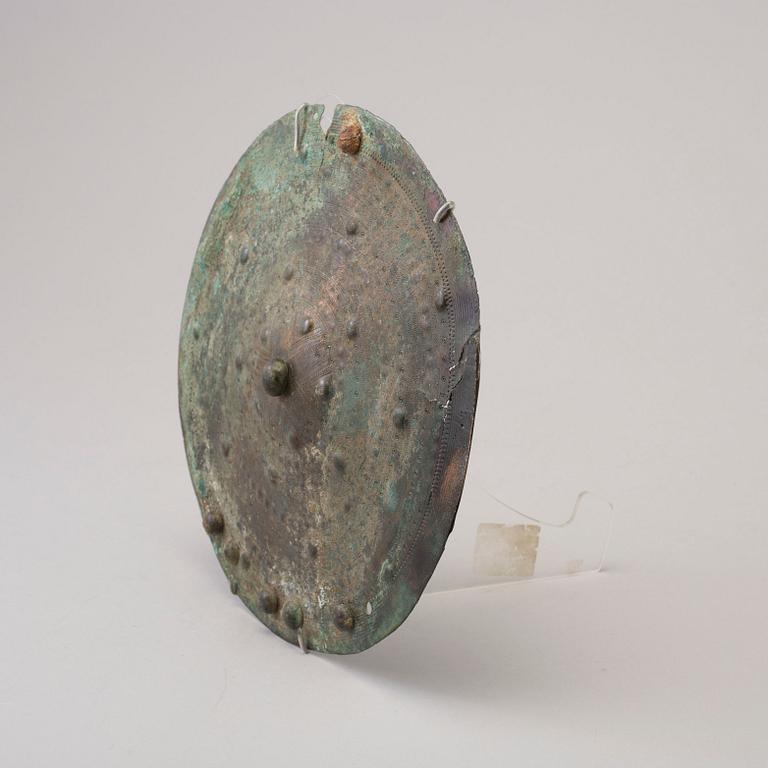 Three 20th century stone objects, with one bronze shield.