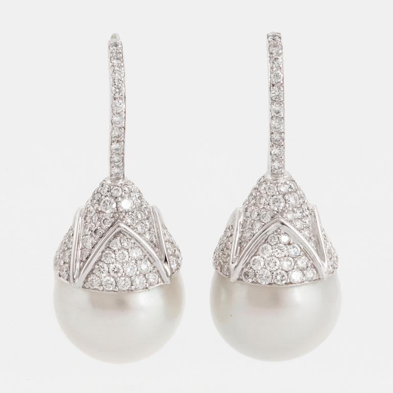 A pair of cultured South sea perl and diamond earrings.