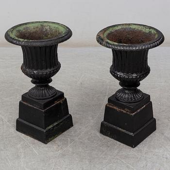 A pair of 20th century cast iron urns.