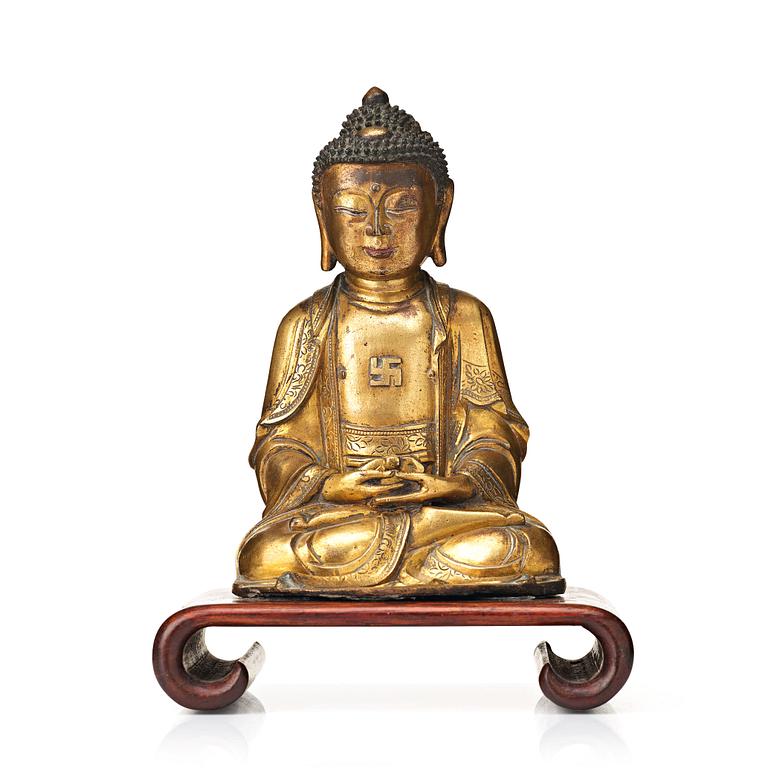 A gilt bronze figure of Amithaba Buddha, Ming dynasty (1368-1644).