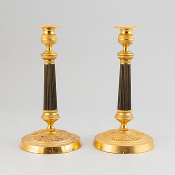 A pair of French Empire candlesticks.