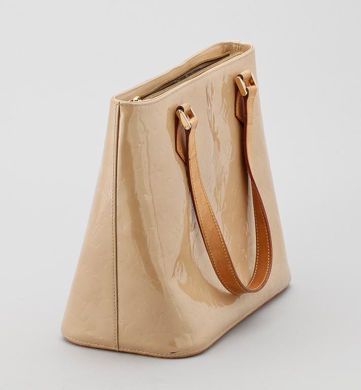 A beige monogram vernis handbag by Louis Vuitton.